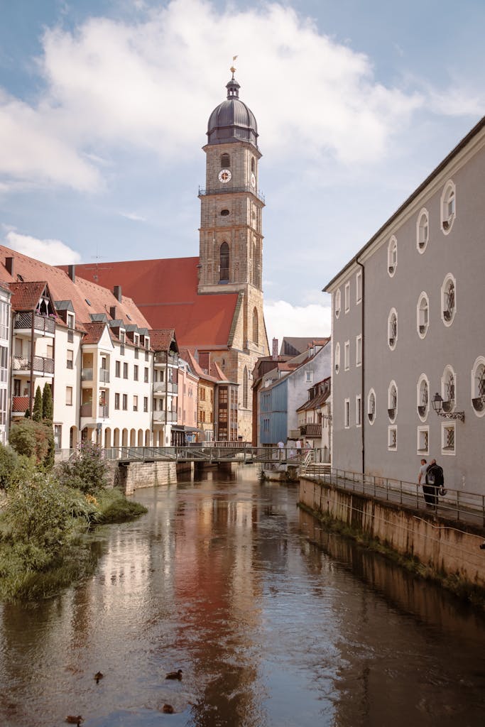 Charming view of the canal and Gothic church tower in Amberg, Germany.